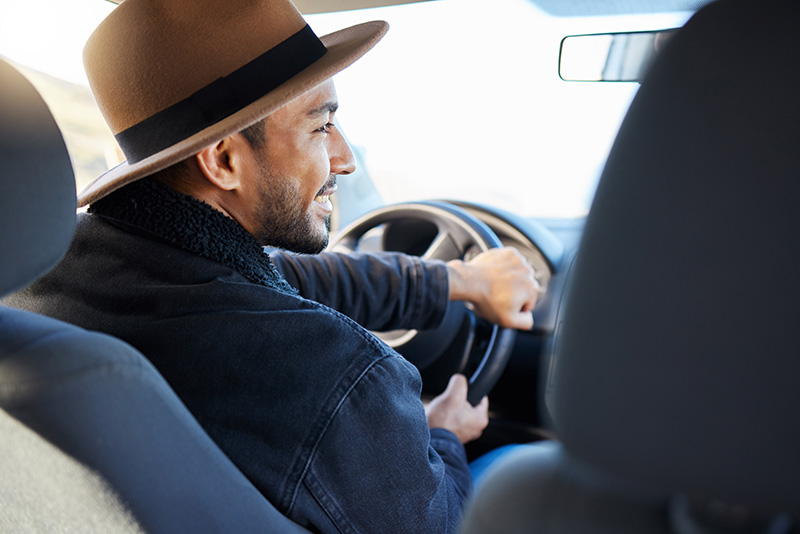 man driving vehicle smiling